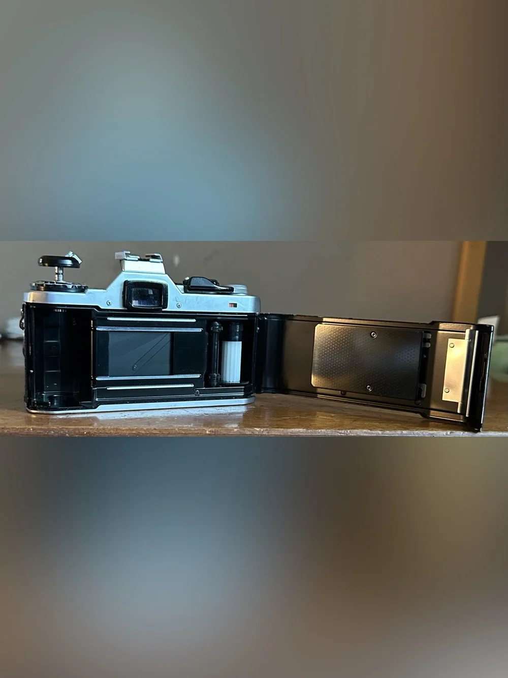 Pentax Silver and Black SLR Camera with Black Lens Cap and Colorful Strap